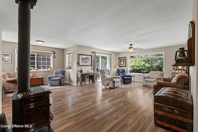 67 Spur Dr, Sandpoint, ID 83864 - living room featuring a ceiling fan, wood finished floors, and a wood stove