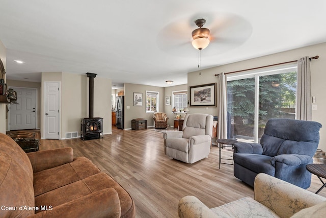67 Spur Dr, Sandpoint, ID 83864 - living room featuring a wood stove, wood finished floors, ceiling fan, and recessed lighting