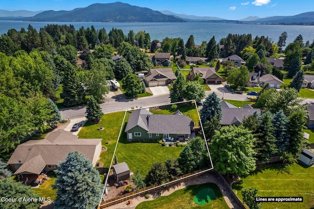 67 Spur Dr, Sandpoint, ID 83864 - aerial view of residential area with property parcel outlined and a water and mountain view