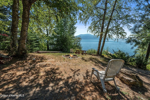 67 Spur Dr, Sandpoint, ID 83864 - view of yard featuring a water and mountain view and an outdoor fire pit