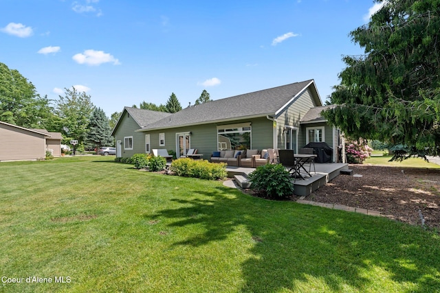 67 Spur Dr, Sandpoint, ID 83864 - rear view of house featuring an outdoor living space, a yard, and roof with shingles
