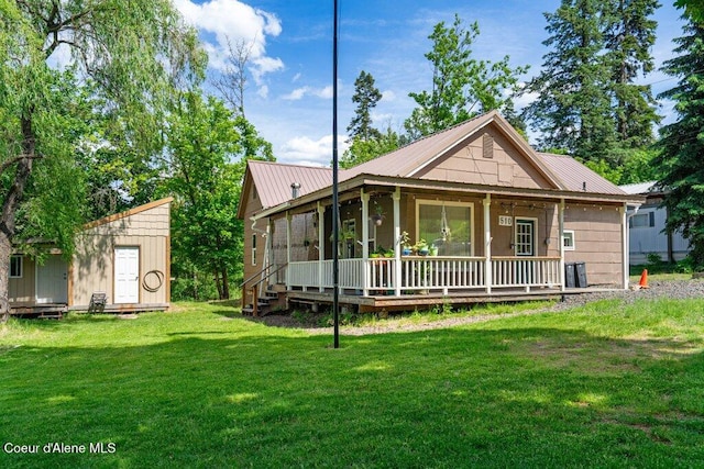 510 S 2nd St, Saint Maries, ID 83861 - view of front of home with a front lawn, a storage unit, a metal roof, and a sunroom