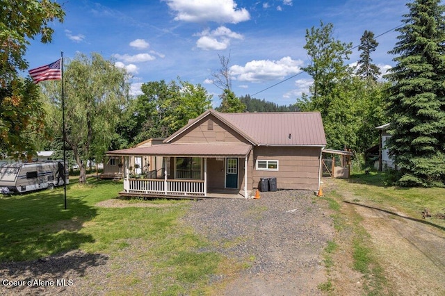 510 S 2nd St, Saint Maries, ID 83861 - back of house with covered porch, a lawn, driveway, and a metal roof