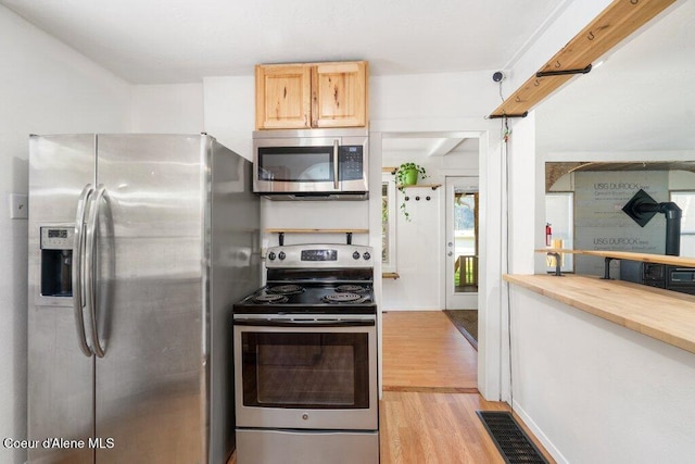 510 S 2nd St, Saint Maries, ID 83861 - kitchen with appliances with stainless steel finishes, light wood-type flooring, wooden counters, and light brown cabinetry