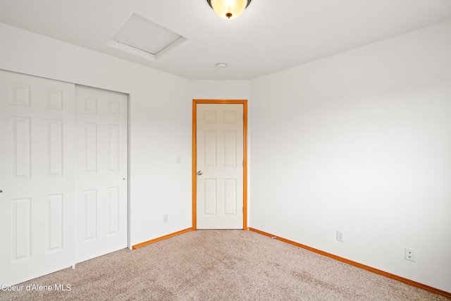 2867 W Tours Dr, Coeur Dalene, ID 83815 - unfurnished bedroom featuring attic access, a closet, and carpet