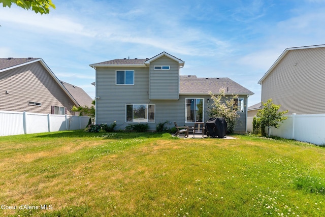 2867 W Tours Dr, Coeur Dalene, ID 83815 - back of property featuring a fenced backyard and a patio