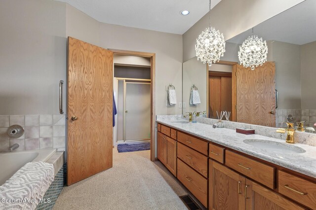 3574 E Tobler Rd # C16, Hayden, ID 83835 - bathroom with double vanity, a chandelier, a garden tub, and a shower stall