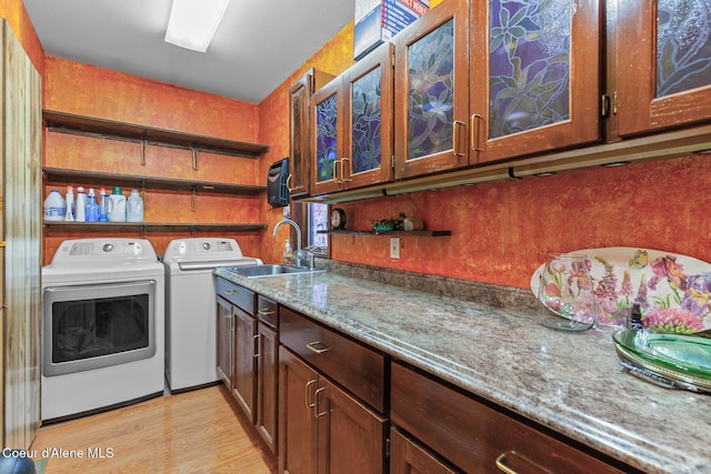 3574 E Tobler Rd # C16, Hayden, ID 83835 - laundry room with separate washer and dryer, light wood-style flooring, and cabinet space