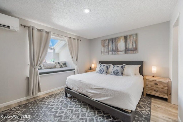 112 Holiday Loop Unit 838, Blanchard, ID 83804 - bedroom featuring wood finished floors, an AC wall unit, a textured ceiling, and baseboards
