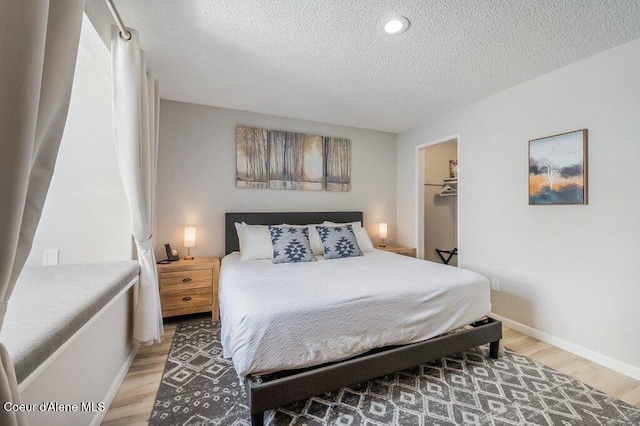 112 Holiday Loop Unit 838, Blanchard, ID 83804 - bedroom with light wood-type flooring, a textured ceiling, baseboards, and recessed lighting