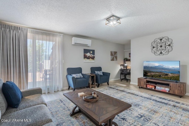 112 Holiday Loop Unit 838, Blanchard, ID 83804 - living area featuring an AC wall unit, wood finished floors, a textured ceiling, and baseboards