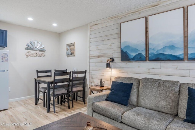 112 Holiday Loop Unit 838, Blanchard, ID 83804 - living area with light wood finished floors, recessed lighting, baseboards, a textured ceiling, and wood walls