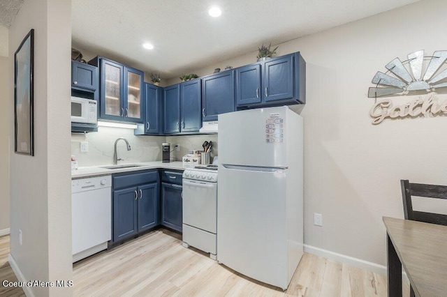 112 Holiday Loop Unit 838, Blanchard, ID 83804 - kitchen with white appliances, a sink, blue cabinetry, light wood-style flooring, and recessed lighting