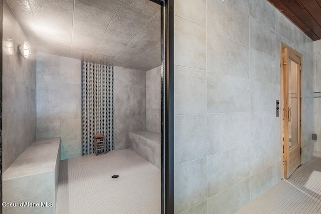 112 Holiday Loop Unit 838, Blanchard, ID 83804 - bathroom with a shower stall, tile patterned floors, and tile walls