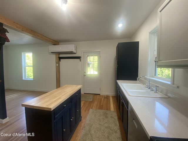 118 Faye St, Mullan, ID 83846 - kitchen with a wall mounted air conditioner, wooden counters, light wood-style floors, healthy amount of natural light, and beamed ceiling