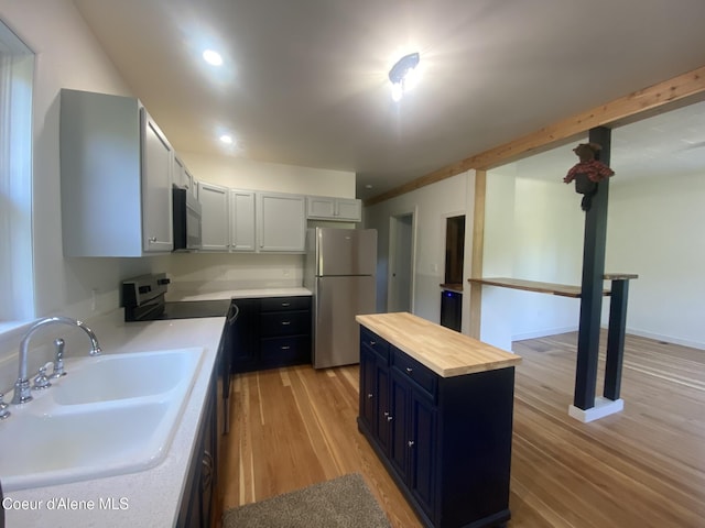 118 Faye St, Mullan, ID 83846 - kitchen featuring freestanding refrigerator, electric range, light wood finished floors, butcher block countertops, and a center island