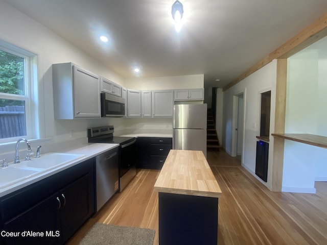 118 Faye St, Mullan, ID 83846 - kitchen with appliances with stainless steel finishes, wooden counters, light wood-style floors, a center island, and recessed lighting
