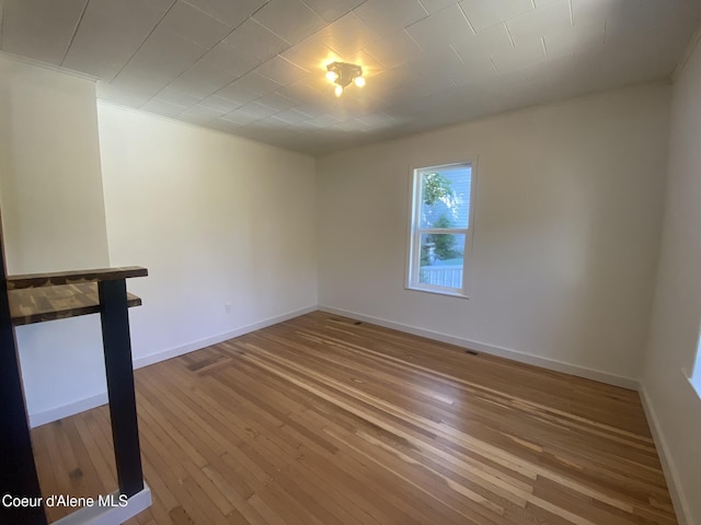 118 Faye St, Mullan, ID 83846 - spare room with wood-type flooring and crown molding