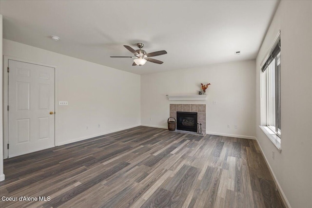 1748 W Durham Dr, Coeur Dalene, ID 83815 - unfurnished living room with dark wood-type flooring, a tile fireplace, a ceiling fan, and baseboards