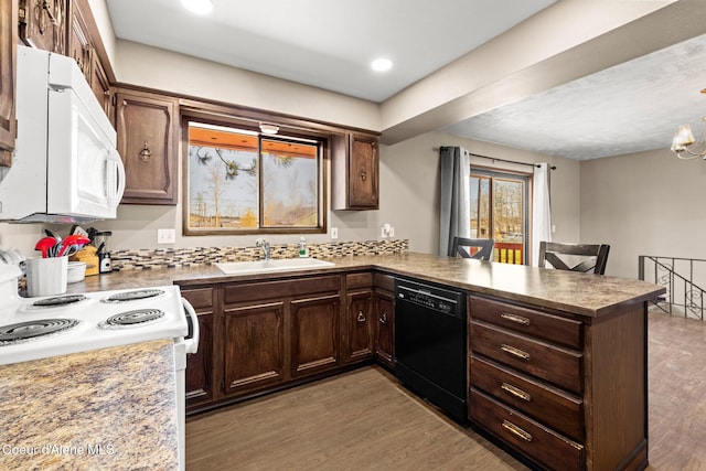 1364 C St, Plummer, ID 83851 - kitchen featuring white appliances, a sink, a peninsula, light wood-style flooring, and dark brown cabinetry