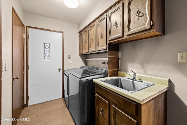 1364 C St, Plummer, ID 83851 - laundry room featuring independent washer and dryer, cabinet space, and light wood finished floors
