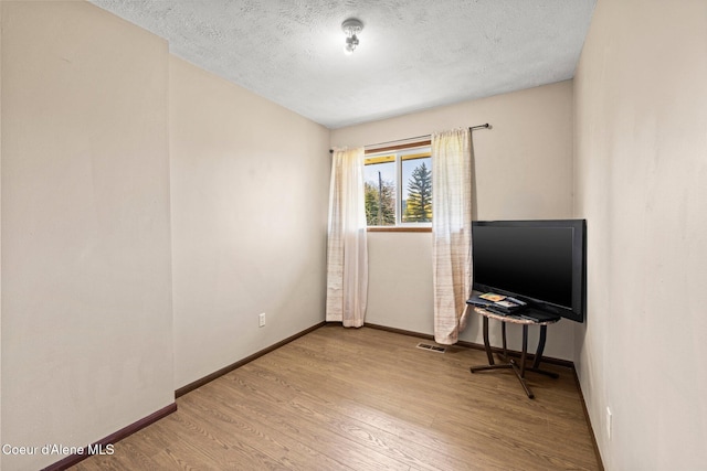 1364 C St, Plummer, ID 83851 - empty room featuring wood finished floors, baseboards, and a textured ceiling