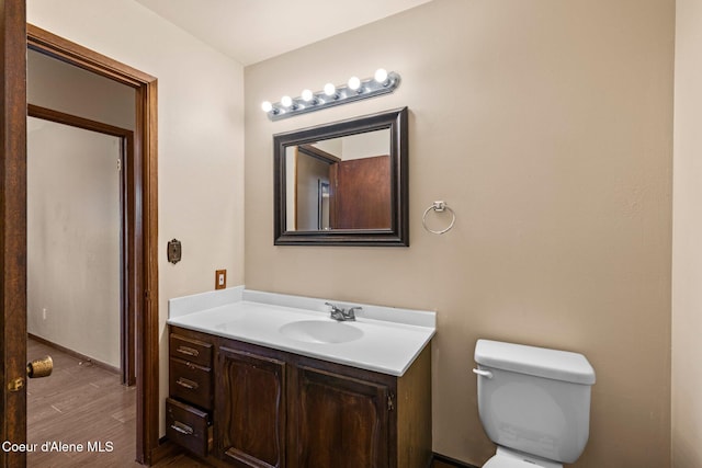 1364 C St, Plummer, ID 83851 - half bathroom with vanity, toilet, and wood finished floors