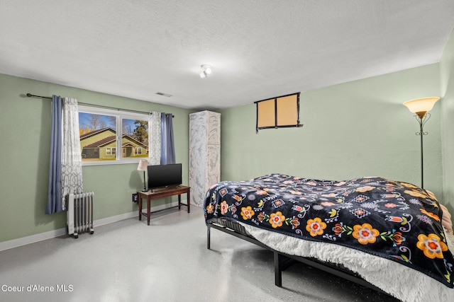 1364 C St, Plummer, ID 83851 - bedroom featuring radiator heating unit, baseboards, and a textured ceiling