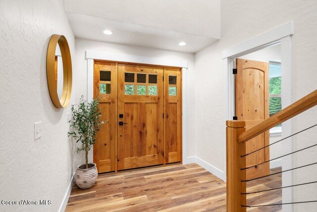 122 Cottonwood Dr, Sagle, ID 83860 - entryway featuring a textured wall, light wood finished floors, recessed lighting, and stairway