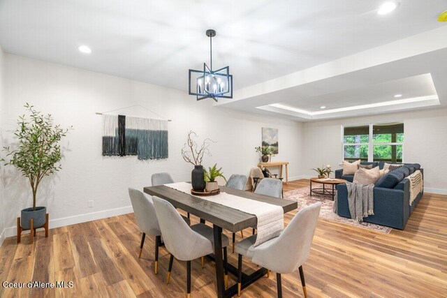 122 Cottonwood Dr, Sagle, ID 83860 - dining room with a chandelier, light wood-type flooring, recessed lighting, and a raised ceiling