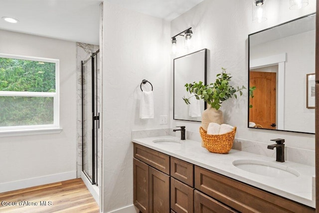 122 Cottonwood Dr, Sagle, ID 83860 - full bath with double vanity, a stall shower, and wood finished floors