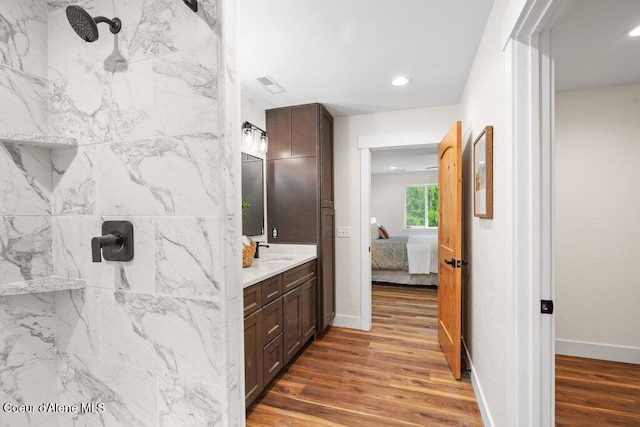 122 Cottonwood Dr, Sagle, ID 83860 - bathroom featuring vanity, wood finished floors, a marble finish shower, connected bathroom, and recessed lighting