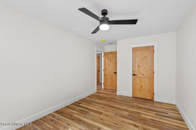 122 Cottonwood Dr, Sagle, ID 83860 - unfurnished bedroom featuring wood finished floors and ceiling fan