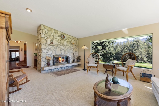 10851 W Pine St, Sandpoint, ID 83864 - living area with carpet floors, a stone fireplace, and lofted ceiling