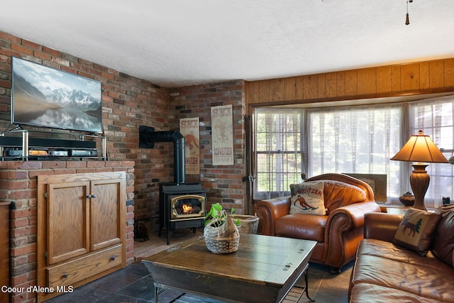 10851 W Pine St, Sandpoint, ID 83864 - living area featuring a wood stove, a textured ceiling, and brick wall