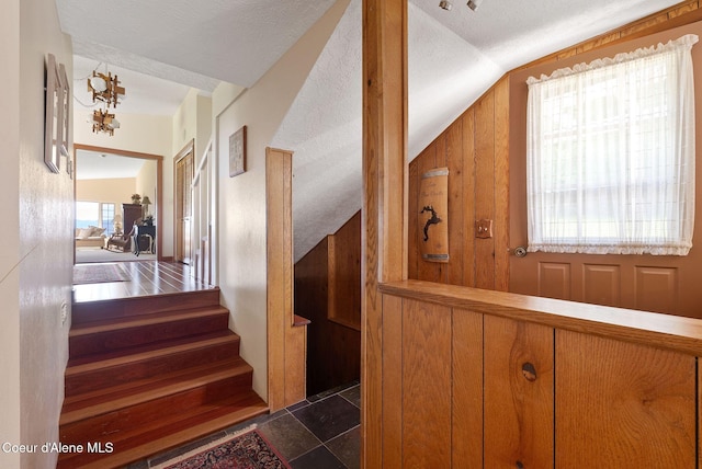 10851 W Pine St, Sandpoint, ID 83864 - staircase featuring vaulted ceiling and wood walls