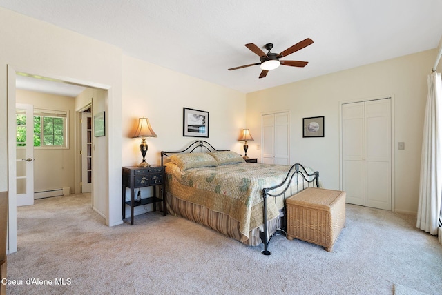 10851 W Pine St, Sandpoint, ID 83864 - bedroom with baseboard heating, carpet floors, multiple closets, and ceiling fan
