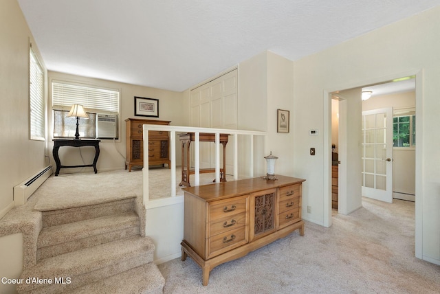 10851 W Pine St, Sandpoint, ID 83864 - staircase with a baseboard heating unit, carpet floors, and cooling unit
