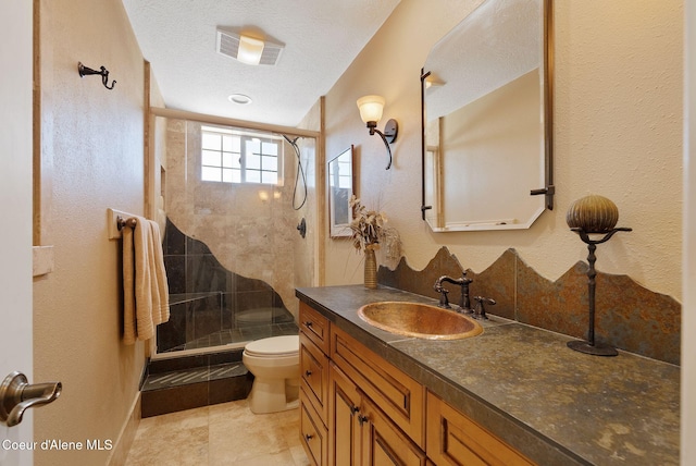 10851 W Pine St, Sandpoint, ID 83864 - bathroom featuring vanity, a stall shower, tile patterned flooring, and a textured ceiling