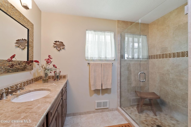 10851 W Pine St, Sandpoint, ID 83864 - full bathroom with vanity, a shower stall, and tile patterned floors