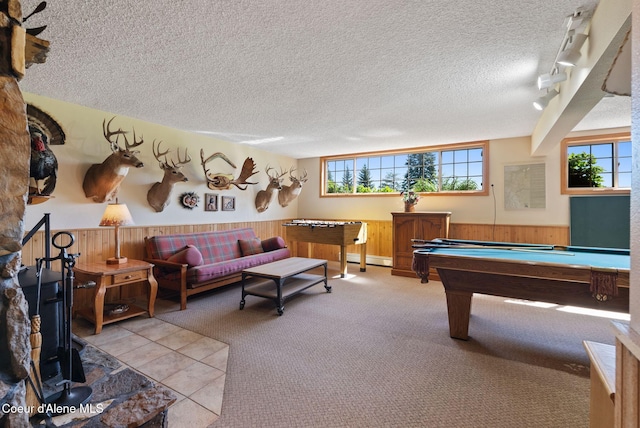 10851 W Pine St, Sandpoint, ID 83864 - playroom featuring wooden walls, a textured ceiling, wainscoting, pool table, and light tile patterned floors
