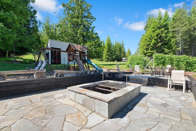 10851 W Pine St, Sandpoint, ID 83864 - view of patio with an outdoor fire pit and a playground
