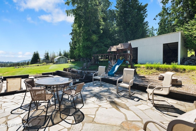 10851 W Pine St, Sandpoint, ID 83864 - view of patio with a storage unit and outdoor dining space