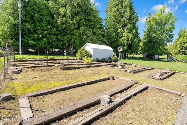 10851 W Pine St, Sandpoint, ID 83864 - view of yard with a vegetable garden and an outbuilding