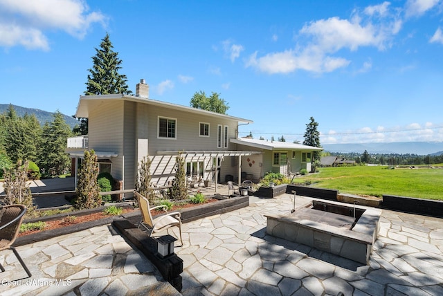 10851 W Pine St, Sandpoint, ID 83864 - view of patio with a fire pit, a mountain view, and a pergola