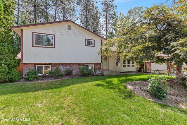 221 S Ridgewood Dr, Post Falls, ID 83854 - view of home's exterior featuring a yard and brick siding