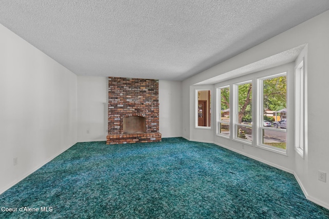 221 S Ridgewood Dr, Post Falls, ID 83854 - unfurnished living room with a textured ceiling, carpet flooring, and a fireplace