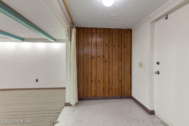 221 S Ridgewood Dr, Post Falls, ID 83854 - empty room featuring wooden walls and concrete floors