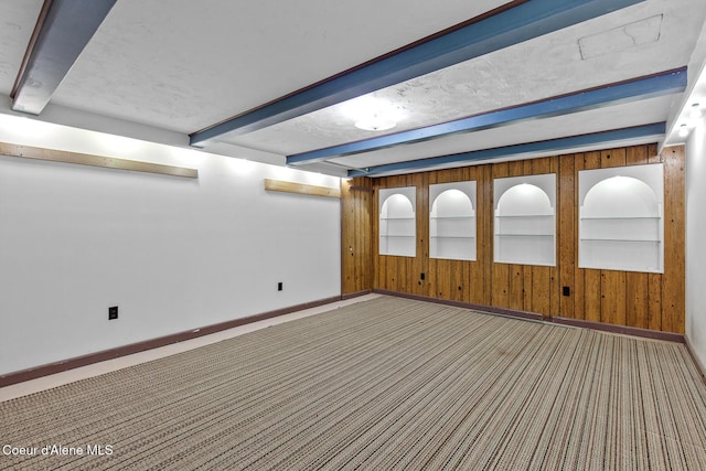 221 S Ridgewood Dr, Post Falls, ID 83854 - empty room with beam ceiling, wood walls, and carpet floors