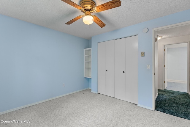 221 S Ridgewood Dr, Post Falls, ID 83854 - unfurnished bedroom with carpet flooring, a closet, a textured ceiling, and ceiling fan